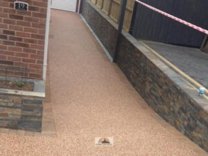 Resin Bound Driveway with New Side Wall and Raised Flower Beds in Rugby